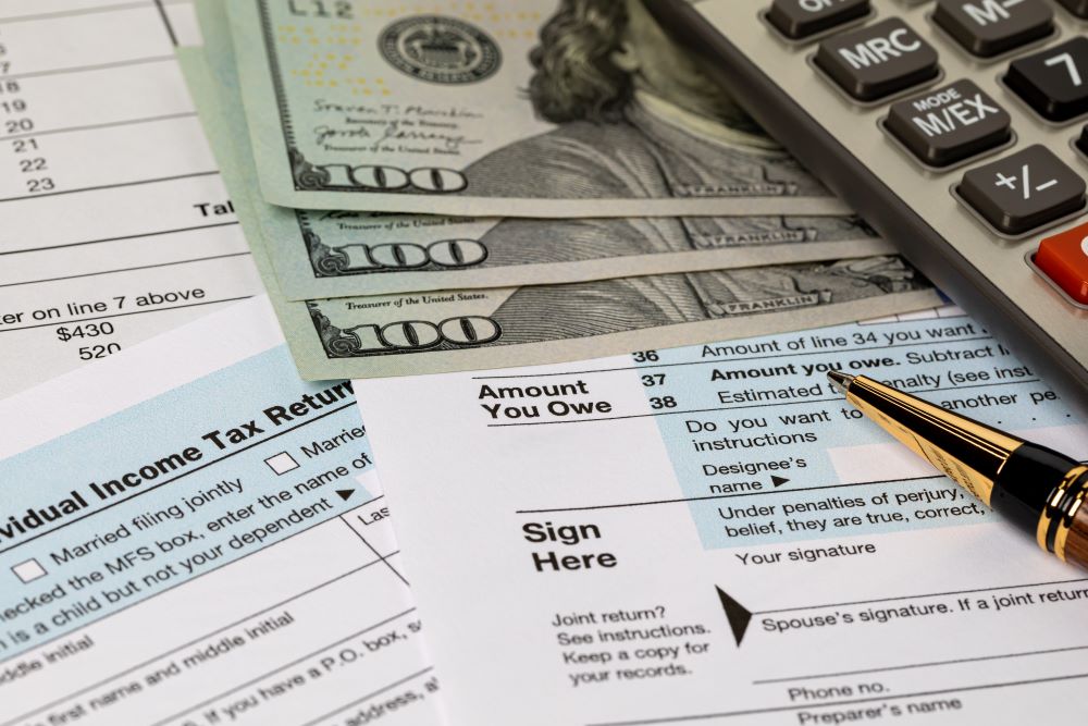 Concept of a tax planning with tax forms, money and other documents displayed on a table
